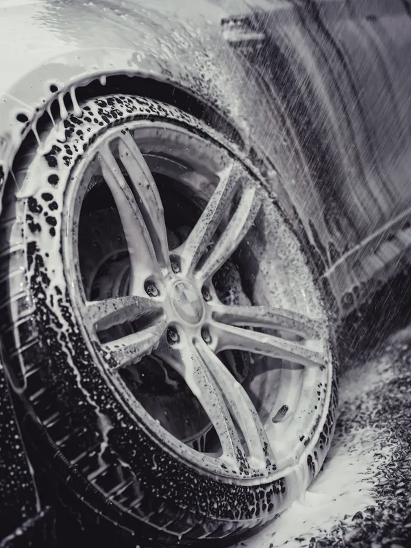 BMW wheel covered in foam during a wash
